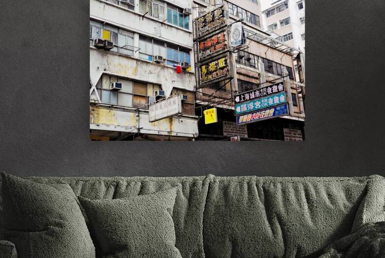 Weathered city buildings in Hong Kong with Chinese signs and lau by Marco Brivio