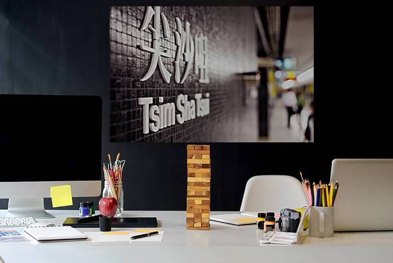 Tsim Sha Tsui subway station sign in Hong Kong at a busy hour by Marco Brivio