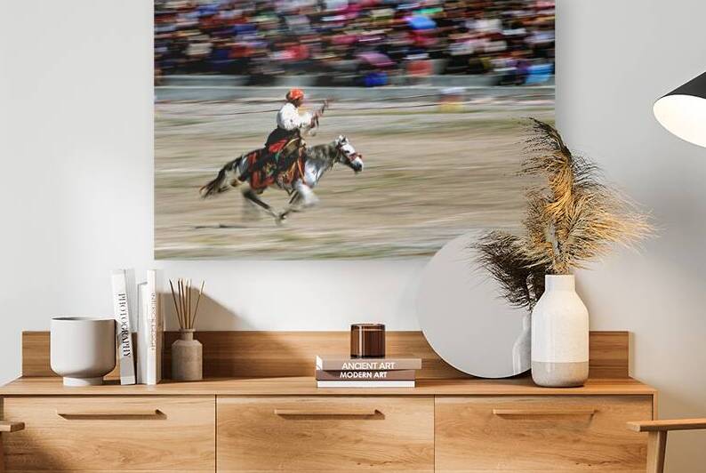 Equestrian rider on a horse races in front of a large crowd in T by Marco Brivio