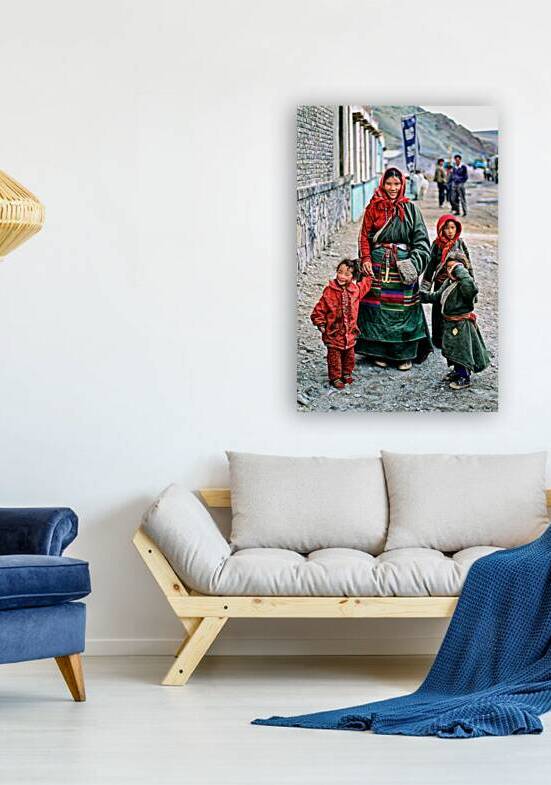 Smiling woman and children in traditional attire in Tibet by Marco Brivio