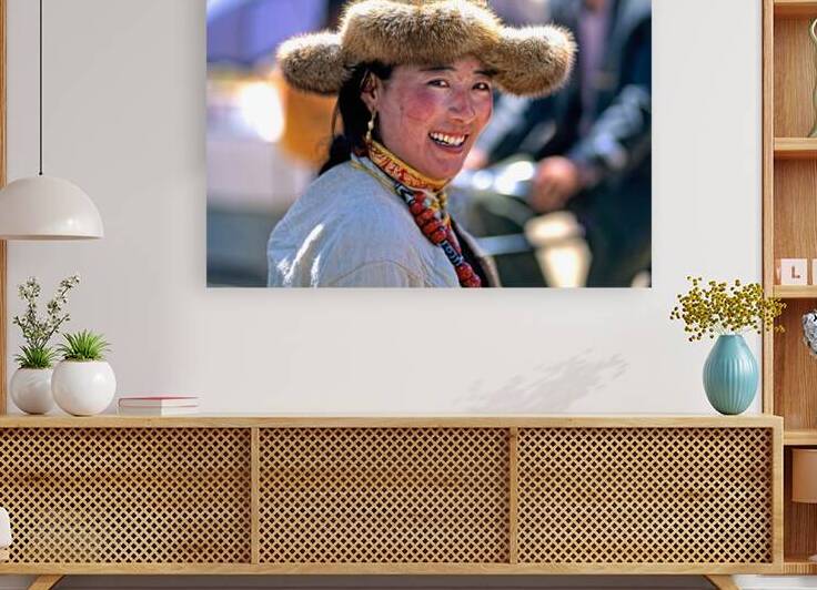 Smiling woman in fur hat and beaded necklace in Tibet market by Marco Brivio