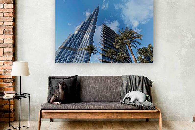 Burj Khalifa among modern buildings and palm trees in Dubai by Marco Brivio
