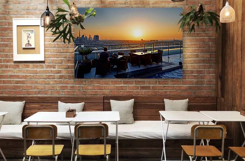 Working on a rooftop with Dubai skyline view at sunset by Marco Brivio