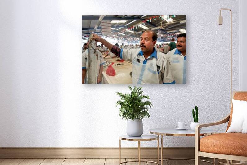 Fish market vendor shows his catch at Dubai market by Marco Brivio