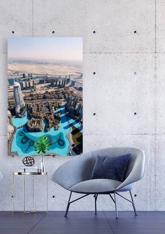 Dubai cityscape shows buildings water and desert from above by Marco Brivio