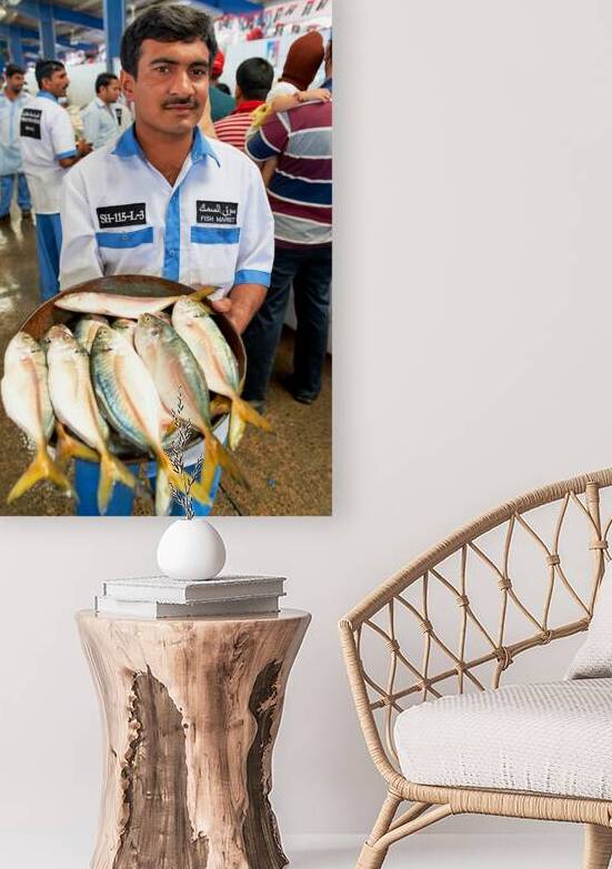 Man holds fresh fish at a market in Dubai UAE by Marco Brivio