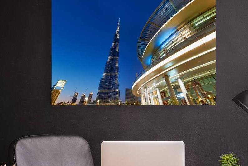 Burj Khalifa at night with modern buildings in Dubai skyline by Marco Brivio