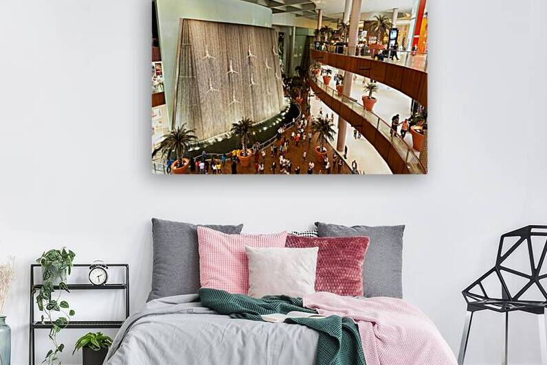 Indoor waterfall with diving figures in Dubai mall during daytim by Marco Brivio