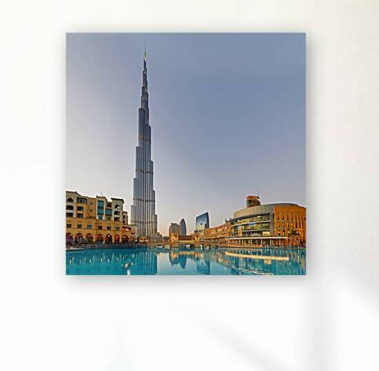Burj Khalifa stands tall over Dubai skyline with water reflectio by Marco Brivio