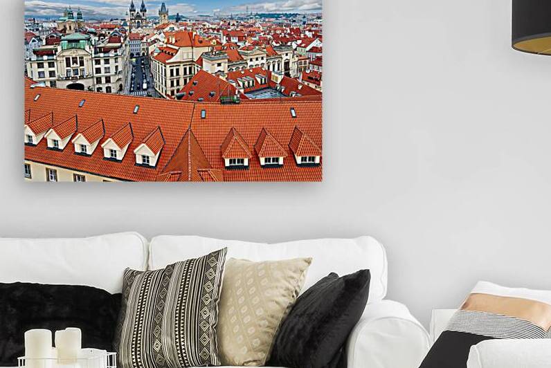 Panoramic view of Pragues red roofs and historic skyline. by Marco Brivio