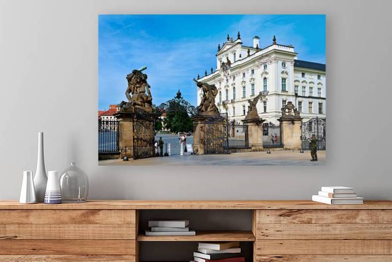 Ornate gates and statues guard a grand European palace. by Marco Brivio