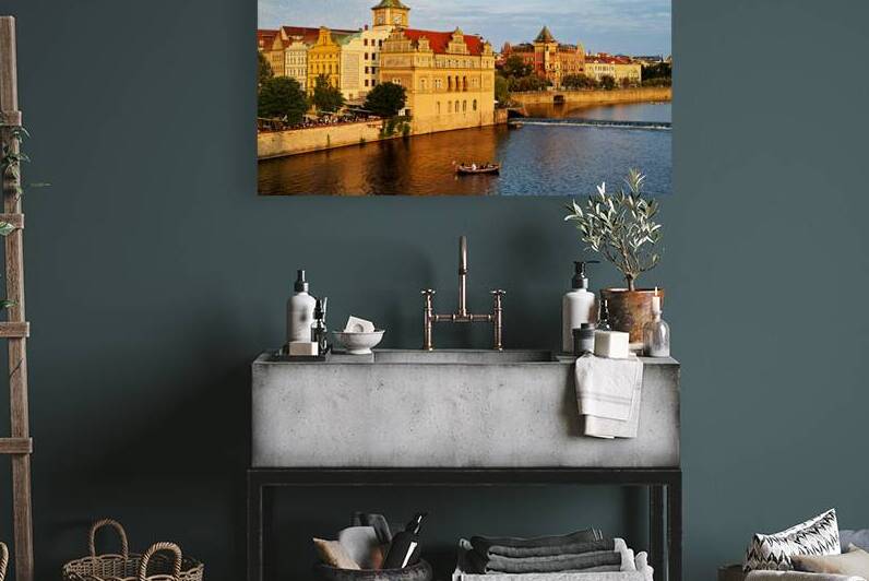 Sunset over Pragues Vltava River historic buildings and boat. by Marco Brivio