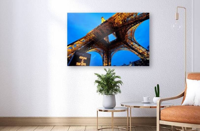 Visitors gather at the Eiffel Tower in Paris during evening hour by Marco Brivio