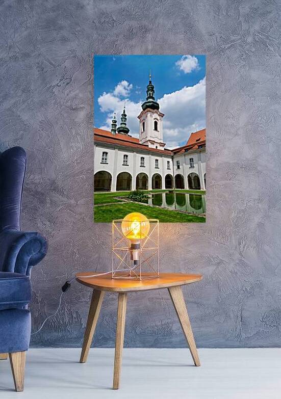 Historic monastery courtyard with pond and prominent towers unde by Marco Brivio