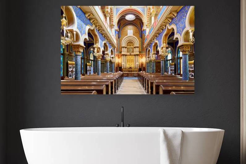 Grand ornate synagogue interior featuring golden ark and pews. by Marco Brivio