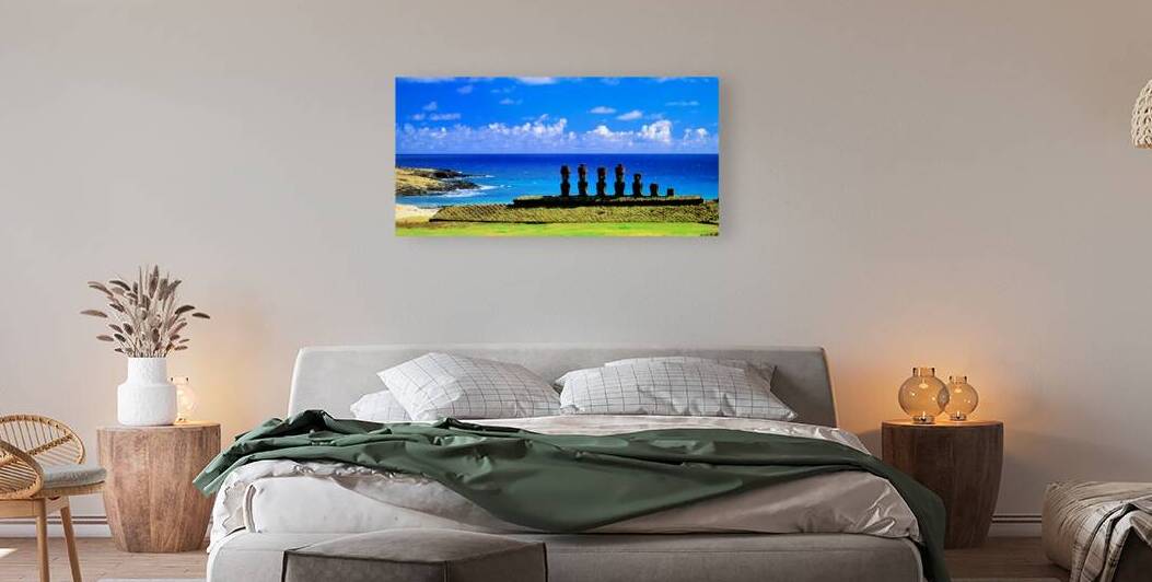 Easter Island Moai statues against a vibrant blue ocean and sky. by Marco Brivio