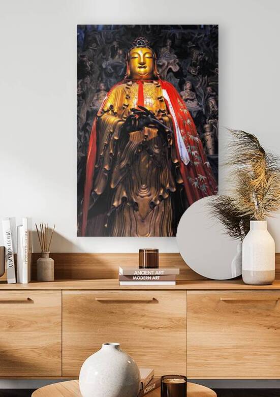 A golden Buddha statue stands in Shanghai wearing a red robe by Marco Brivio