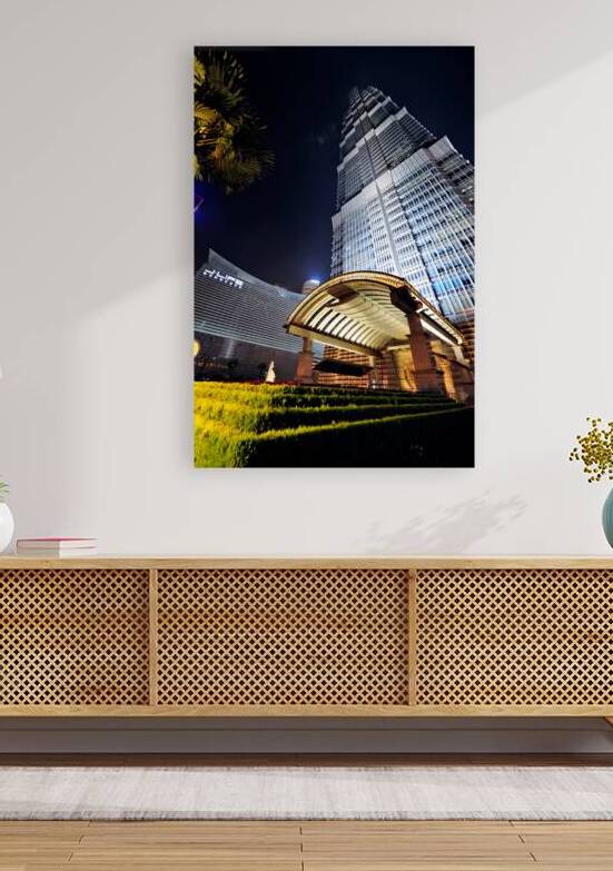 Modern skyscraper with bright entrance at night in Shanghai by Marco Brivio