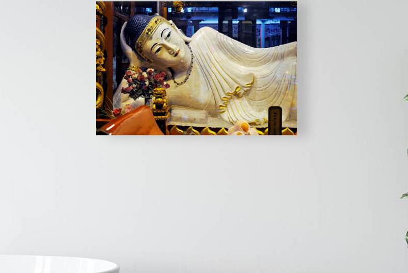 Reclining Buddha statue in Shanghai temple with flowers and gold by Marco Brivio