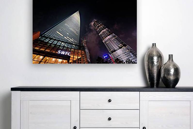 Bright lights of Shanghai skyscrapers at night in China by Marco Brivio