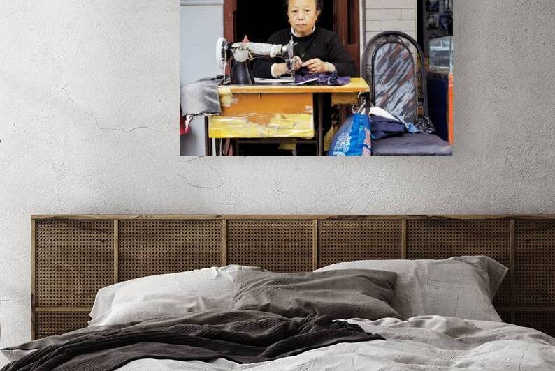 Elderly woman sews at machine in Shanghai China by Marco Brivio