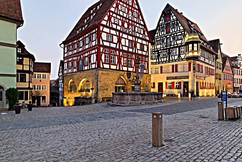Rothenburg ob der Tauber shows its historic buildings at sunset by Marco Brivio