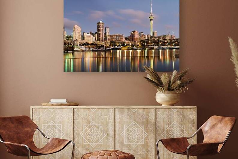 Auckland skyline with buildings and Sky Tower during evening by Marco Brivio