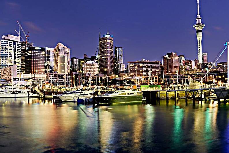 View of Auckland skyline from Viaduct Harbour at sunset by Marco Brivio