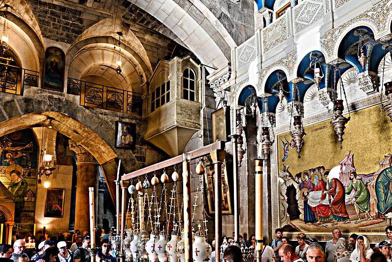 Visitors explore the church of the Holy Sepulchre in Jerusalem by Marco Brivio