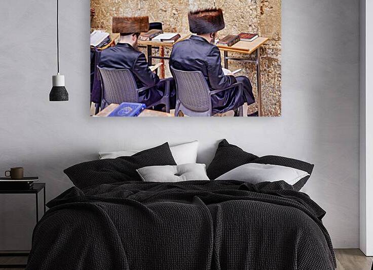 Orthodox Jews sit at tables by the Western Wall in Jerusalem by Marco Brivio