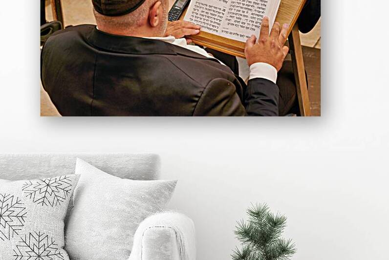 Orthodox jew praying with a book at the wailing wall in jerusale by Marco Brivio