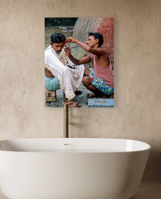 Street barber at work in Kolkata on a busy urban day by Marco Brivio