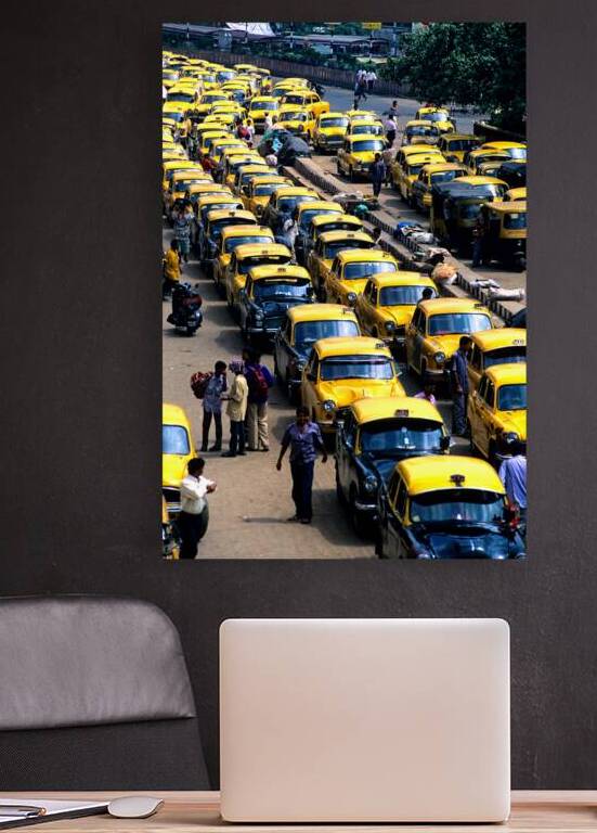 Taxi parking in Kolkatas busy streets during daytime by Marco Brivio