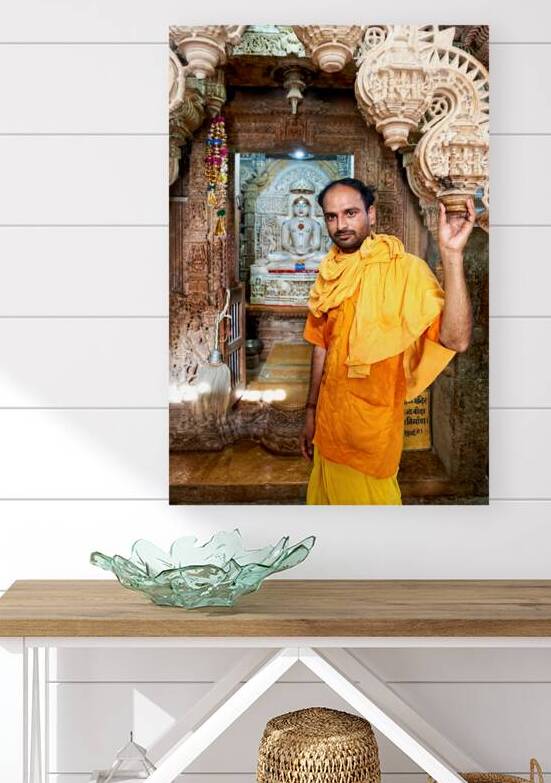 Hindu monk stands near statue in Jaisalmer Jain temple by Marco Brivio