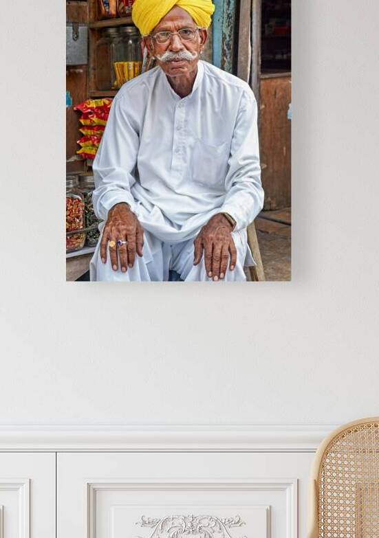 Senior man sitting in Jaisalmer market in Rajasthan India by Marco Brivio
