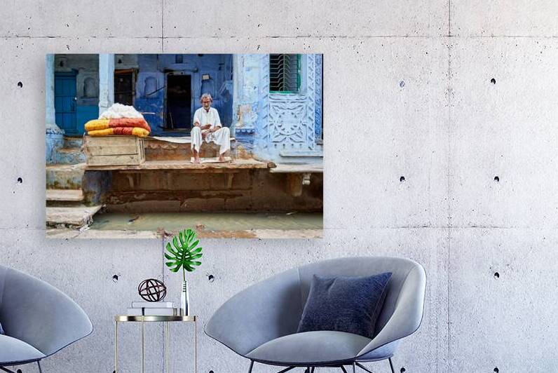 Portrait of an old man sitting by a blue building in Bundi Raja by Marco Brivio