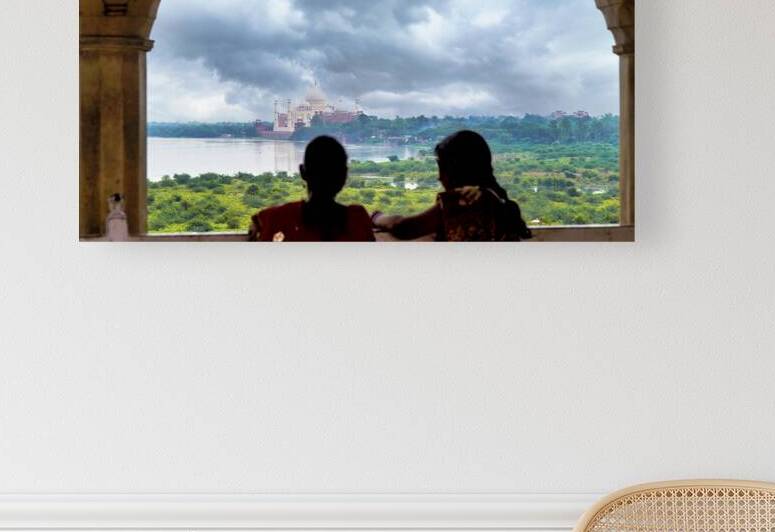 Visitors look at the Taj Mahal through an arch in Agra India by Marco Brivio