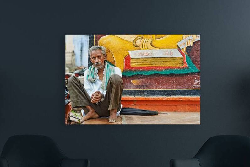 Old man sitting near mural in Bundi Rajasthan India by Marco Brivio