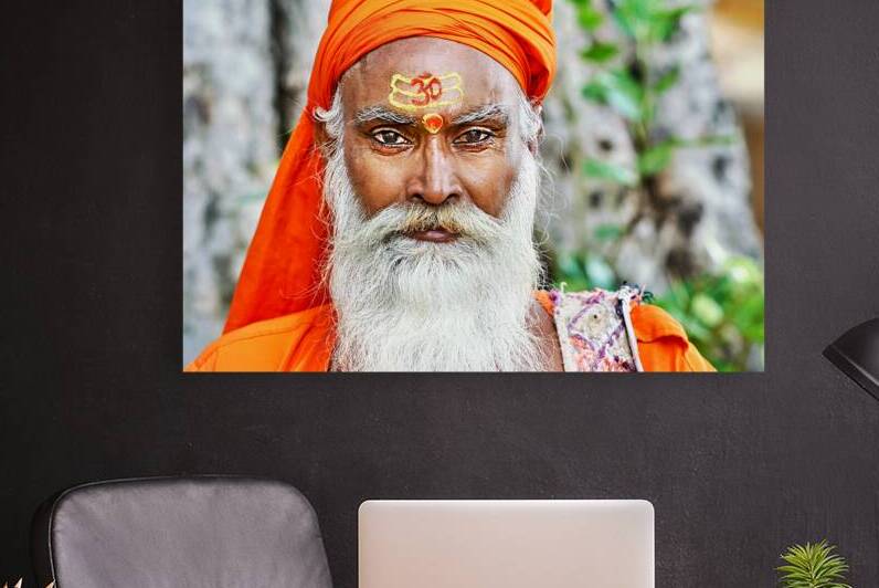 Holy man in Rajasthan Jaipur stands near a tree in the sunlight by Marco Brivio