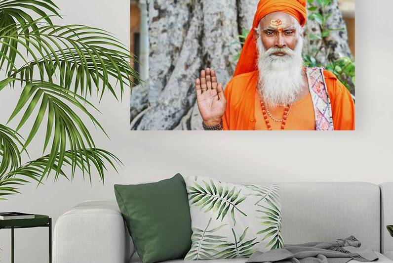 Sadhu in orange robe stands near tree in Jaipur Rajasthan by Marco Brivio