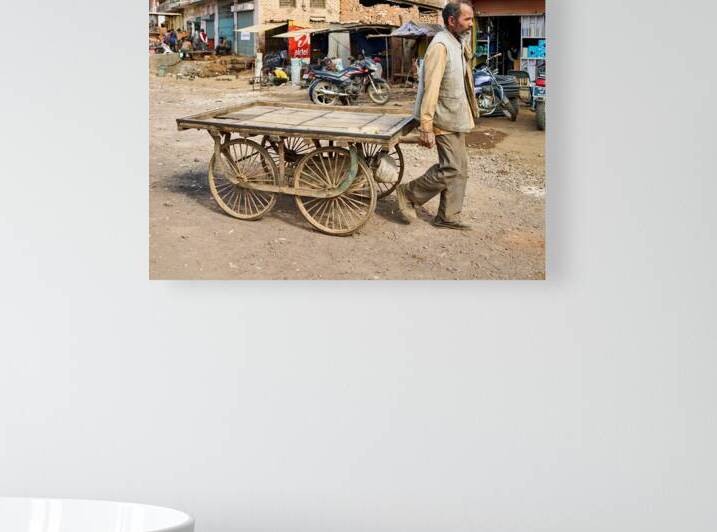 Man pulls an empty cart in Orchha Madhya Pradesh India by Marco Brivio