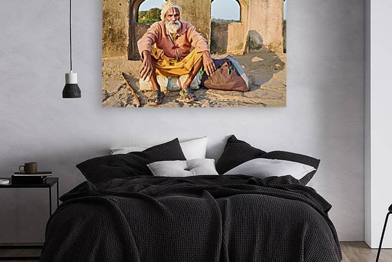 Holy man sitting outside historic building in Orchha India by Marco Brivio