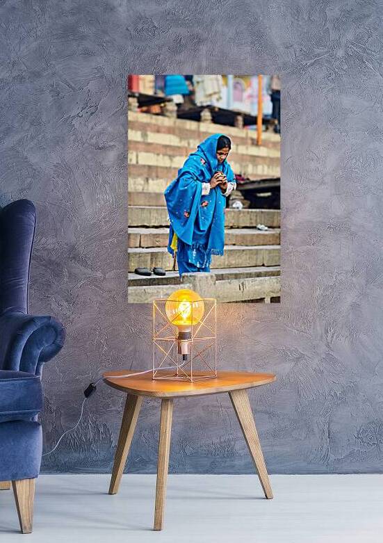 Woman praying by the Ganges in Varanasi during morning hours by Marco Brivio