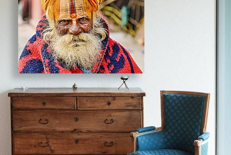 Old holy man in Varanasi wearing bright colors in Uttar Pradesh by Marco Brivio