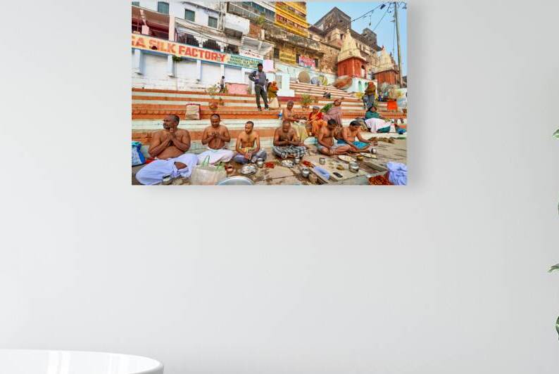 Barechested men offer prayers by the Ganges River in Varanasi by Marco Brivio