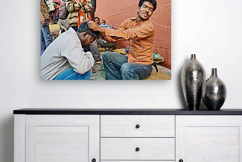 Barber cuts hair at shop in Varanasi Uttar Pradesh India by Marco Brivio