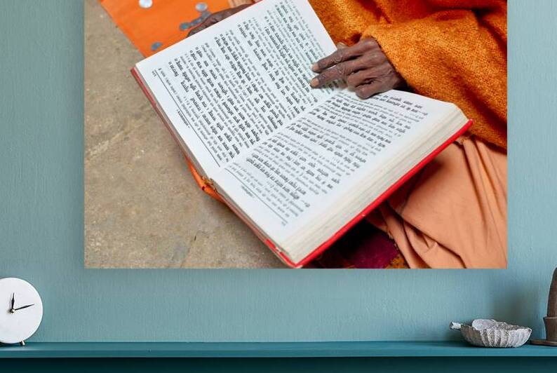 Man reads Hindu texts and prays in Varanasi India by Marco Brivio