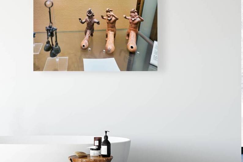 Displays of ancient artifacts are shown in glass cases by Marco Brivio