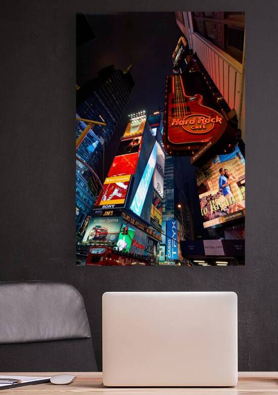 Bright lights in Times Square near the Hard Rock Cafe at night by Marco Brivio