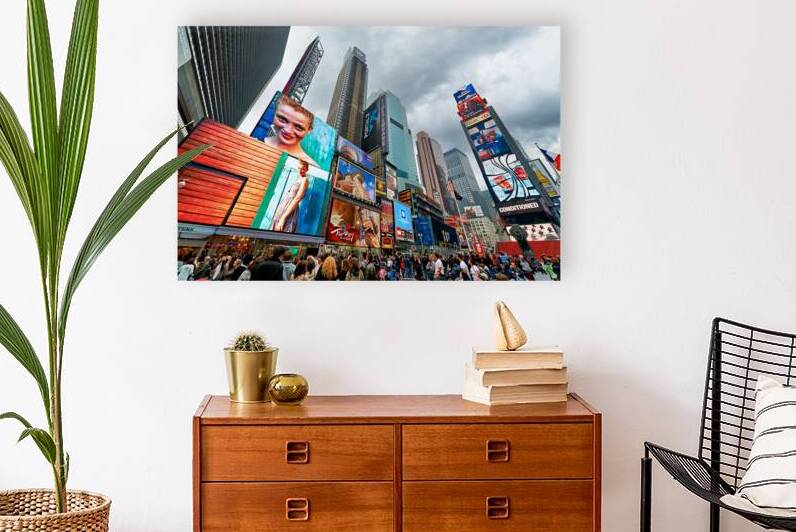 Crowd gathers in Times Square Manhattan during a cloudy day by Marco Brivio